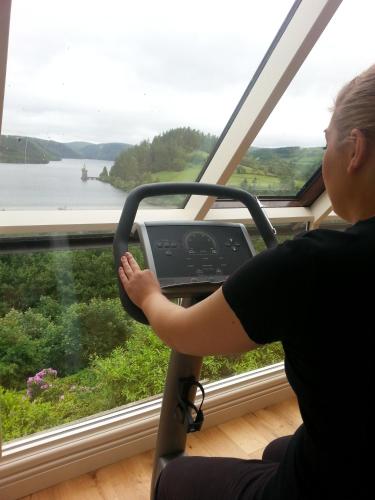 a woman driving a bus looking out a window at Lake Vyrnwy Hotel & Spa in Llanwddyn