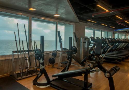 a gym with a view of the ocean at Hotel Luzeiros São Luis in São Luís