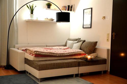 a bed in a room with a couch and a table at Ferienwohnung RelAction, bis 4 Personen, Mit Fahrradkeller! 600m Bikepark! Erdgeschoss mit Terasse! WIFI! in Winterberg