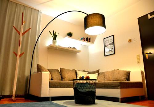 a living room with a couch and a lamp at Ferienwohnung RelAction, bis 4 Personen, Mit Fahrradkeller! 600m Bikepark! Erdgeschoss mit Terasse! WIFI! in Winterberg