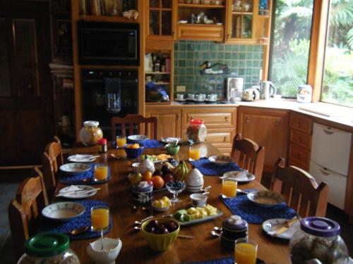 a dining room table with food and fruit on it at TWYNHAM at Kinloch in Kinloch