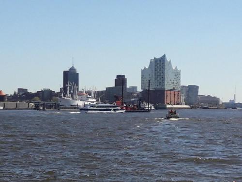 a view of a city from the water with a boat at Gemütliches Häuschen im Alten Land in Jork