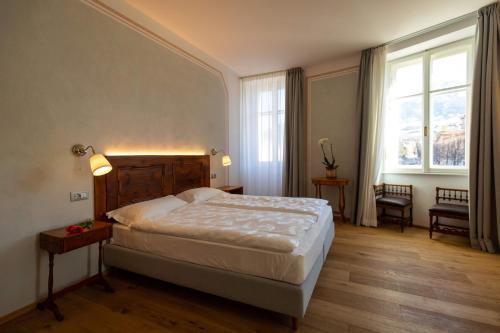 Un pat sau paturi într-o cameră la Torrione Trento