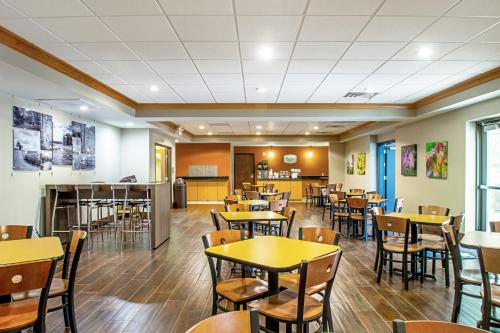 an empty dining room with tables and chairs at MainStay Suites Madison - Monona in Madison