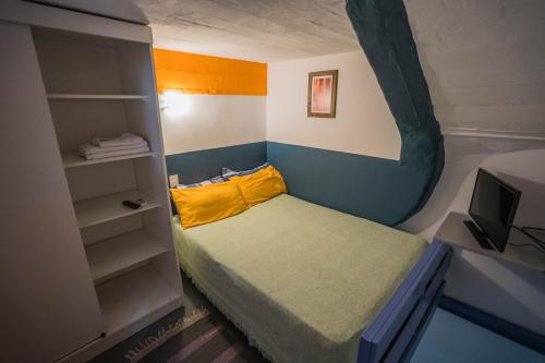 a small bedroom with a bed and a book shelf at Villa Crespo Arena in Buenos Aires