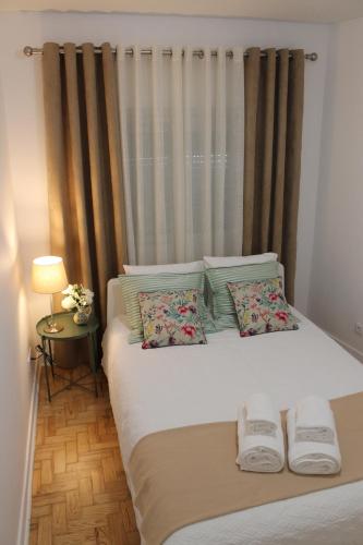 a bedroom with a bed with two pillows and a window at Madre Deus Guest House in Lisbon