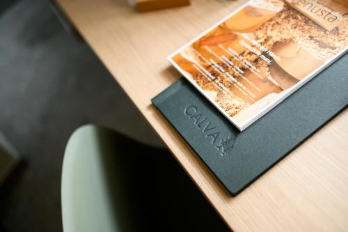 a wooden table with a book and a magazine at Calva B&B Apartments in Malles Venosta