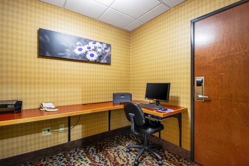 an office with a desk with a computer and a chair at MainStay Suites Madison - Monona in Madison