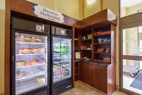 a refrigerator with its door open in a store at MainStay Suites Madison - Monona in Madison