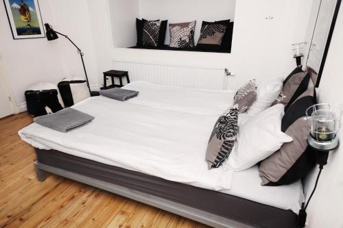 a bedroom with a bed with white sheets and pillows at City Backpackers Hostel in Stockholm