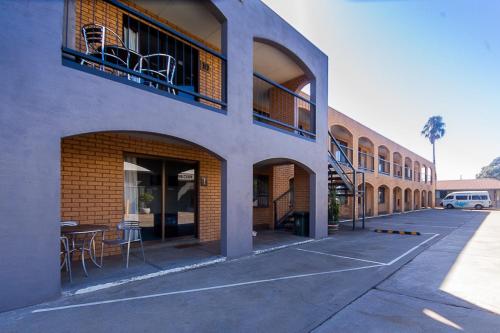a building with a table and chairs outside of it at Lake Mulwala Hotel in Mulwala