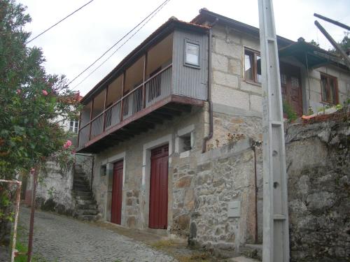a building with a balcony on top of it at D. Maria São Pedro de Balsemão in Lamego