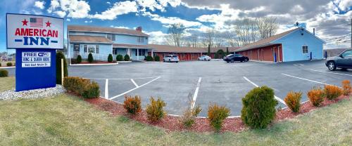 a parking lot in front of an american inn at American Inn in Branford
