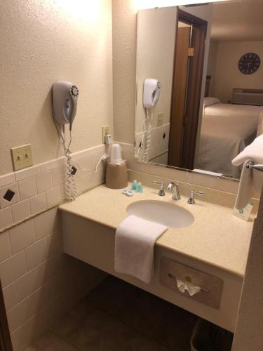 a bathroom with a sink and a mirror at Yellowstone Village Inn and Suites in Gardiner