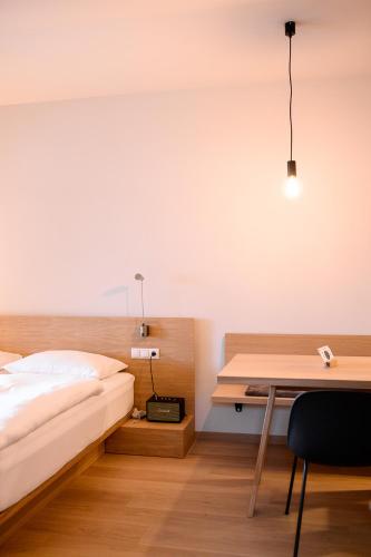 a bedroom with a bed and a desk and a table at Calva B&B Apartments in Malles Venosta