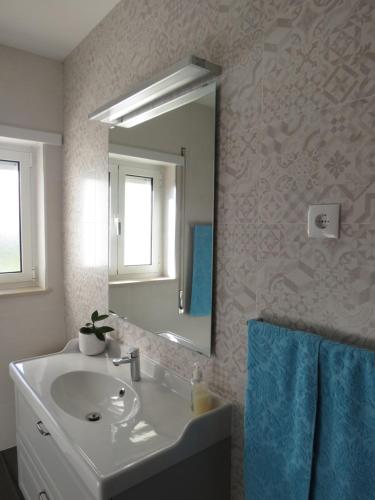 a bathroom with a sink and a mirror at Villa Vitória in Nazaré
