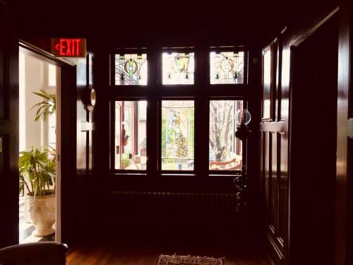 a room with a door with windows and a potted plant at Beaconsfield Bed and Breakfast - Victoria in Victoria