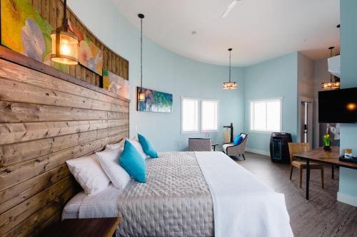 a bedroom with a large bed with blue pillows at The Barn B&B Walla Walla in Walla Walla