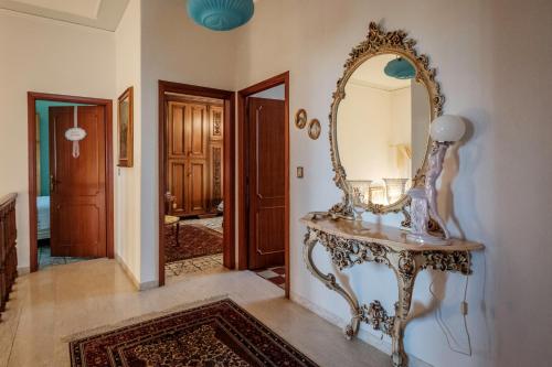 a dressing table with a mirror on a wall at La terrazza del Bimbo in Fucecchio