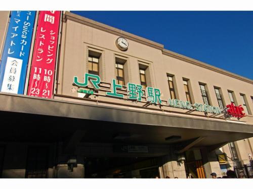 a building with a sign on top of it at KOKO HOTEL Shimbashi Onarimon - formerly Hotel Wing International Shimbashi Onarimon in Tokyo