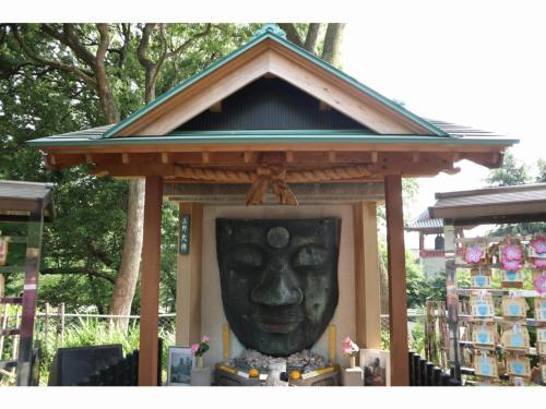a statue of a face in a gazebo at KOKO HOTEL Shimbashi Onarimon - formerly Hotel Wing International Shimbashi Onarimon in Tokyo