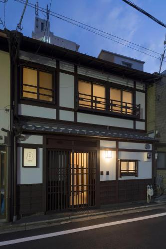 a building with a gate and a building at Yoshimigura Machiya House in Kyoto