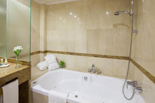 a bath tub in a bathroom with a shower at Hotel Royal Plaza in Ibiza Town