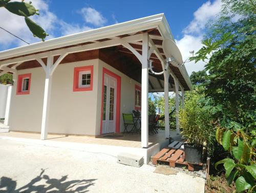 a small house with awning on a patio at Grenadier in La Trinité