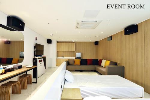 a room with a bed and a living room at Biennale Hotel in Gwangju