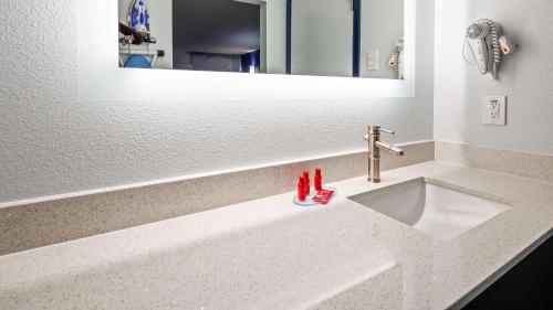 a bathroom counter with a sink and a mirror at SureStay Plus Hotel by Best Western Sacramento Cal Expo in Sacramento