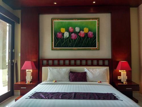 A bed or beds in a room at D'Kubu Legian