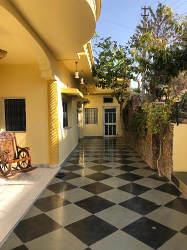a hallway with a black and white checkered floor at Jai Villa Homestay in Udaipur