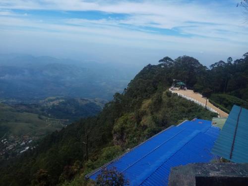 a view from the top of a mountain with a blue roof at RIO Homestay in Haputale