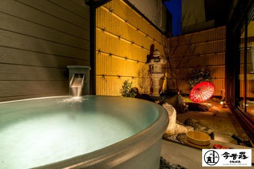 a bath tub with water coming out of it at KONJAKUSO Osaka Tsuruhashi "KAKUJU" in Osaka