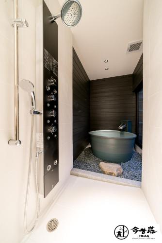 a bathroom with a tub and a shower at KONJAKUSO Osaka Tsuruhashi "KAKUJU" in Osaka