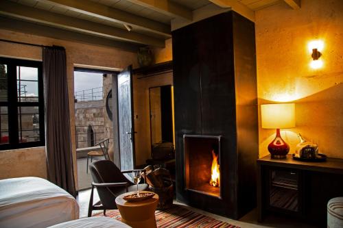 a hotel room with a fireplace in a bedroom at Carus Cappadocia in Goreme