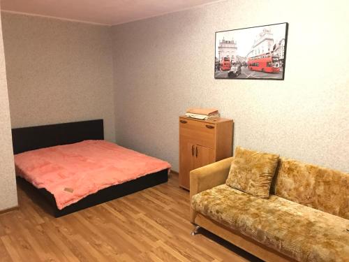 a living room with a bed and a couch at Apartment G-Kvartal Planernaya 7k4 in Moscow