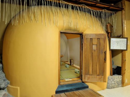a bath room with a tub and a mirror at Heihachi Tea House Inn in Kyoto