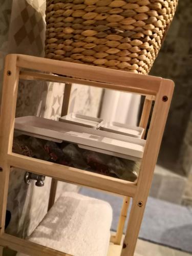 a wooden stool with a basket on top of it at Cozy Getaway in Nicosia in Yukarı Lakatamya