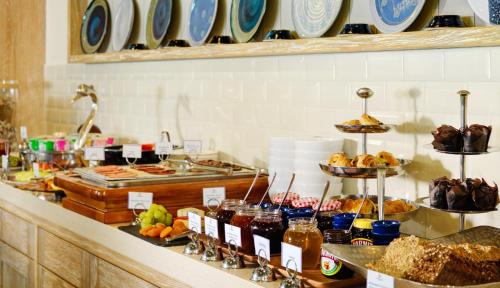 a buffet with bread and other food on a counter at Inchydoney Island Lodge & Spa in Clonakilty