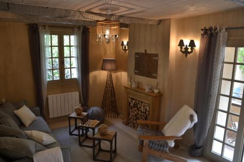 a living room with a couch and a fireplace at La Maison de Moustiers in Moustiers-Sainte-Marie