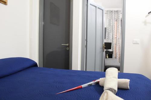 a bedroom with a blue bed with a toy on it at Monolocale da Angelo in Castellammare del Golfo
