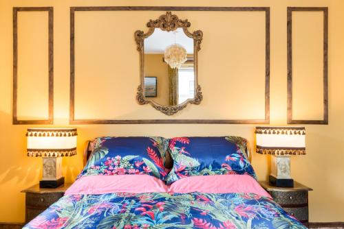 a bedroom with a bed with two lamps and a mirror at The Park At Holyrood in Edinburgh