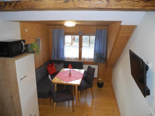 a small dining room with a table and chairs at Entschleunigungshof Huberbauer in Kötschach