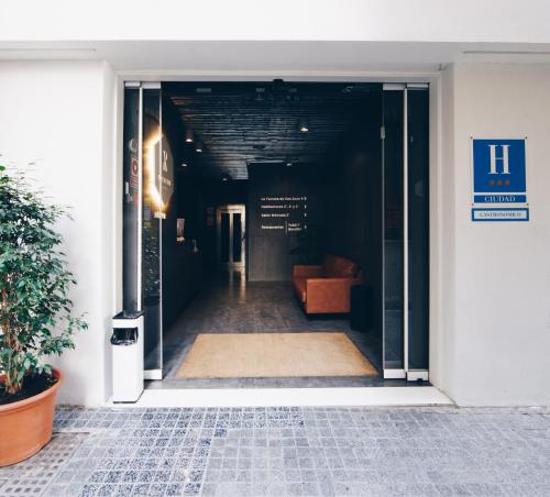 an open door of a building with a couch in it at Málaga Premium Hotel in Málaga