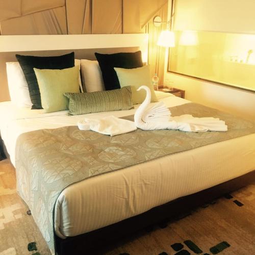 a bedroom with a bed with a swan on it at Sayaji Indore in Indore