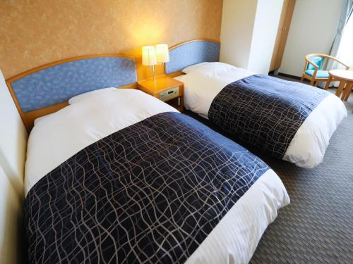 Ένα ή περισσότερα κρεβάτια σε δωμάτιο στο APA Hotel Obihiro Ekimae