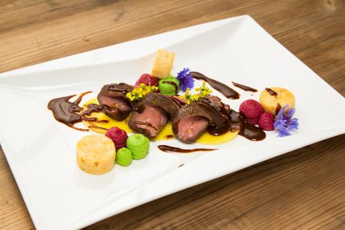 a white plate with a dessert on a table at RAMSI euer Familienhotel in Hermagor