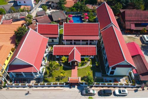 an overhead view of a building with red roofs at Sunrise Garden House - Luang Prabang in Luang Prabang