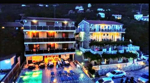 a view of a city at night with buildings at Apartments Dragišić in Sveti Stefan